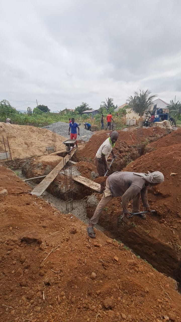 Construction workers carrying out foundation excavation and concrete works