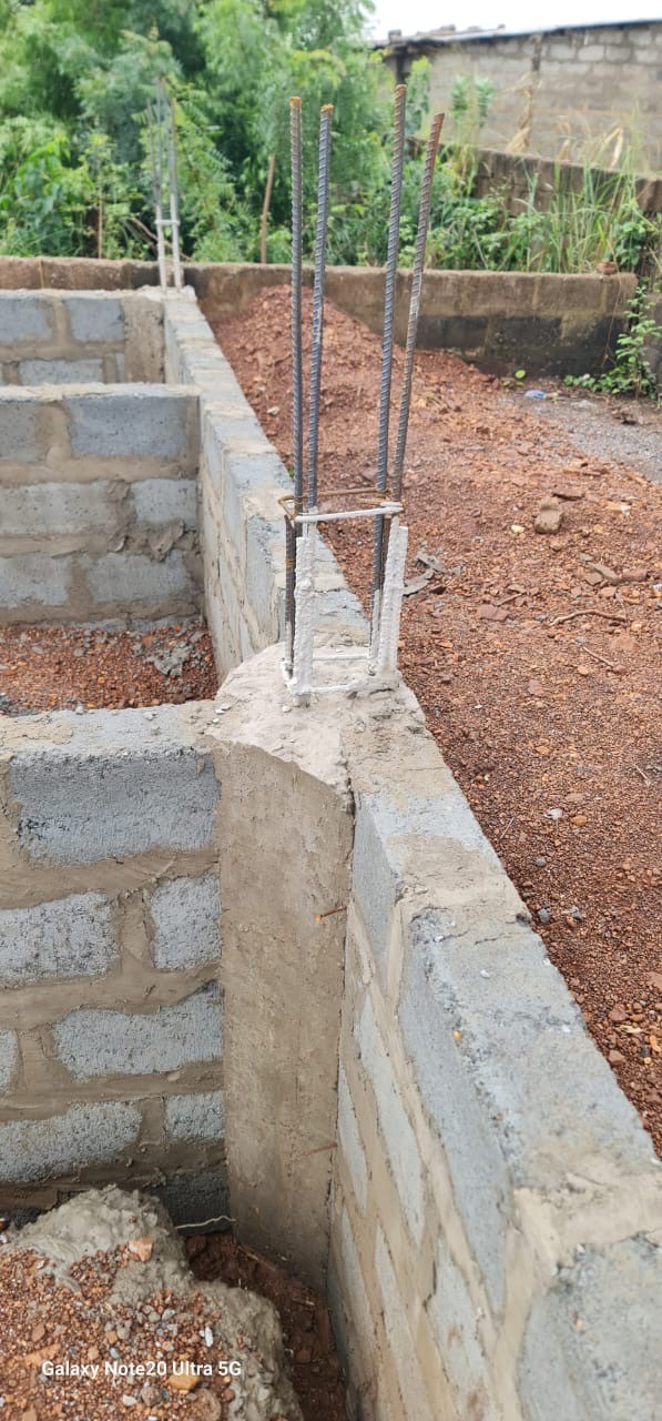 Reinforcement bars and concrete column starter detail on a building foundation